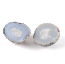 Pair of Light Blue Agate Specimens: A pair of agate specimens. These pieces have been cut and polished with sky blue interiors. These specimens come from separate geodes.