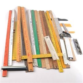 Yardstick and Ruler Assortment: An assortment of yardsticks and rulers. Included are several different vintage yardsticks and rulers with advertisements.
