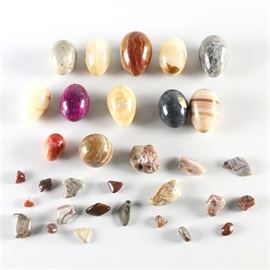 Polished Egg Collection: A collection of decorative polished stone eggs. The eggs are made of various materials such as marble, onyx, and alabaster among others.