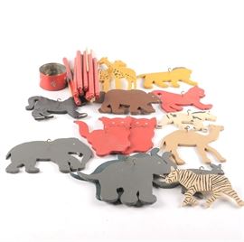 Collection of Wooden Animal Decor: A collection of wooden animal decor. This assortment comes with twenty-three wooden bars. Animals include cat, giraffe, elephant, lion, camel, kangaroo, and bear.