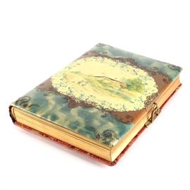 Nineteenth–Twentieth Century Photo Album: A photo album with contents dating from circa the late nineteenth century to the mid-twentieth century. This album features an illustrated front cover and a red floral and foliate pattern to the back cover and spine. The album contains chiefly photographs of people, including babies and children, some of which are formal studio portraits; as well as some photographs of buildings and scenes showing people on a farm. Also included are assorted postcards, one of which is postmarkd 1924.