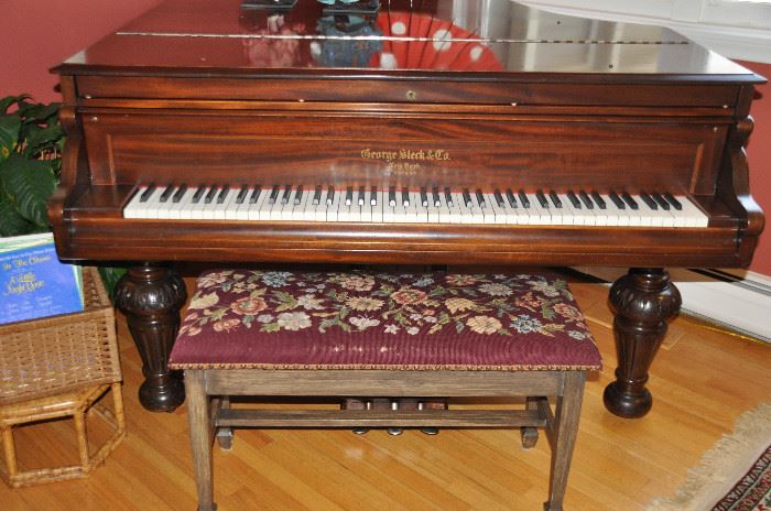 Vintage mahogany George Steck Baby Grand Piano, shown with a vintage needlepoint piano stool
