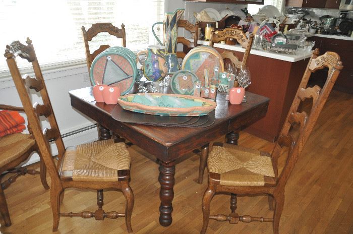 Antique rustic 40" square dining/game table shown with 4 of the 12 ladder back dining chairs with rush seats available