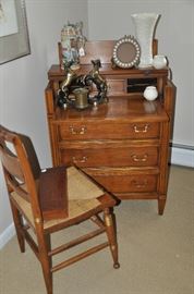 Vintage Women's writing desk with pull out leather top, shown with a vintage rush seat side chair 