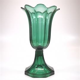 A mid 19th century pressed glass Tulip vase, New England, probably Boston & Sandwich Co.  Emerald Green, having an octagonal bowl with flared rim, raised on an octagonal base.  Minor wear; a few very small and minor nicks to the underside of the base, large ground chip at one petal.  9 3/4" high.  ESTIMATE $200-300