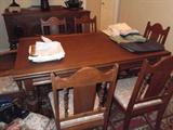 Antique table and chairs, both ends extend.