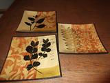A set of three decorative plates.