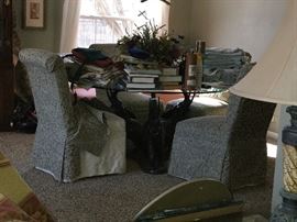 Sorry for this cluttered photo, but wanted to show you the glass top and the VERY unique base. The armless chairs do have slip covers on them for ease of cleaning. I'll get another photo posted when we clear this puppy off!