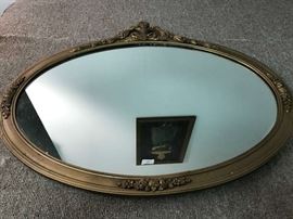 Oval mirror that measures 29" x 24"