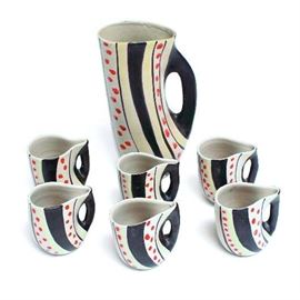 Nino Strada Handmade Pottery Set: This is a vintage Mid-Century Modern handmade Italian pottery set attributed to famed Italian designer Nino Strada. It features a hand painted pitcher and six matching mugs. All six mugs are marked on the bottom and read “Piemme Italy 572/B”. The pitcher is unmarked.