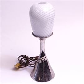 Laurel Table Lamp: A Laurel table lamp. The lamp features a silver tone mushroom lamp metal base with a chrome finish and a textured white glass shade. “Laurel Lamp Manufacturing Co.” is labeled to the underside.