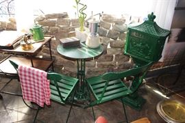 Late 19th to Early 20th Century Imported French 'Verte Anglais' Patio Set w/ 2 Iron & Oak-Slat Chairs + Iron Patio Table (Original Paint on Table);  An Imported French Solid Iron Countryside Pedestal Mailbox, matched in same 'Verte Anglais' (Circa 1900); Far Left- Antique Wood and Iron Garden Cart; Back Wall Cobblestones All Available (Paris, France, Circa 1600-1625)