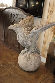 Antique Imported French Cast Limestone Garden Statue of "Eagle on Globe."      Large Imported French Fireback Plate w/ Column on Each Side and Crossed Batons at Center Below Manufacture Date Stamped into the Cast Iron Reading "1733" - Width 37in x Height 34in