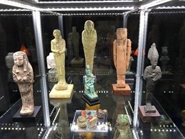 Ancient Egyptian Artifacts- New Kingdom Terracotta Shabti; One-Of-A-Kind Style of Bichrome Fainece Isis Nursing Horus Votive Offering Statuette; Extremely Rare Large Faience Figure of Egyptian Demiurge "Ptah;" Middle Kingdom Wooden Tomb Figure w/ Original Movable Arms; Carved Limestone Head of A Ptolemaic Queen, Almost Certainly a Depiction of  Arsinoe II the Sister-Wife of Ptolemy II; Two Bronze Figures of Osiris, God of the Underworld; Extra Large Green Faience Ushabti w/ 9 Bands of Hieroglyphics on Legs- Probably Saite Period/26th Dynasty; Assorted Carnelian Agate Scarabs, Schist and Steatite Heart Scarabs, Amulet Plaques, and MUCH MUCH More!