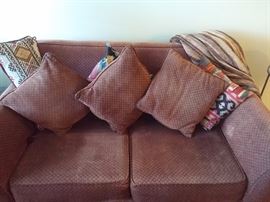 1 upholstered loveseat with 4 matching throws