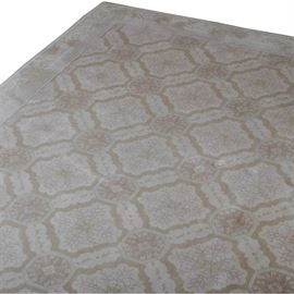 Hand Woven Trellis Garden Wool Area Rug: A hand woven wool area rug. This large indoor rug has an allover cream, peach, and tan trellis pattern with floral accents, on a cream field, with an attached cream, tan, and grey floral patterned border.