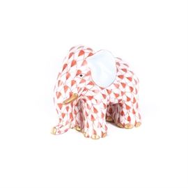 Herend Hungary Fishnet Elephant Figurine: A Herend red fishnet elephant figurine. This piece depicts the standing figure of an elephant hand painted in the classic red fishnet pattern with 24K gold accents on the trunk, tusks, and feet. The figurine is marked on the underside with the Herend seal.