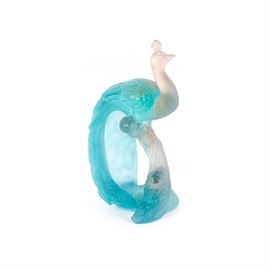 Daum France Pate de Verre Crystal Peacock: A Daum France pate de verre crystal peacock. This pate de verre crystal figurine depicts a white peacock with flowing blue textured tail feathers on a white and blue stump like base. Piece is etched on the bottom. Pâte de verre is a kiln-casting method that means “paste of glass”. The general premise is to mix frit granules with a binder then applying the glass to the inner surface of a negative mold.