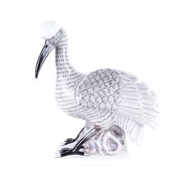Raynaud Limoges Carven Fabulous Bird's "Ibis-Peacock": A Raynaud Limoges Carven Fabulous Bird’s Ibis-Peacock. This porcelain bird figurine depicts the ibis peacock from Limoges Fabulous Birds series and features layered feathers, long beak and clawed feet in white, gold, black, and grey colors on a rectangular base. Piece is marked on the bottom and includes a certificate of authenticity.