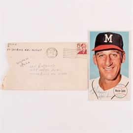 1964 Topps Warren Spahn #31 Autographed Baseball Card with Envelope from Spahn: A 1964 Topps Warren Spahn #31 autographed baseball card with envelope addressed from Spahn. Included is a 1964 Topps Warren Spahn #31 autographed baseball card, the card features a portrait of him dressed in his iconic Milwaukee Braves hat. The lot also includes an envelope from Spahn addressed to Leo Raymond from 1980 when the card was autographed.