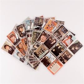 Complete Set of 1964 Colored Beatles Cards: A complete set of 1964 colored Beatles color cards. The set features features sixty four cards #1 to #64, each with white bordering to the cards and still frame photographs of the iconic Beatlemania. Each of these cards feature a colored front of Paul, George, John and Ringo and a question and answer on the verso.