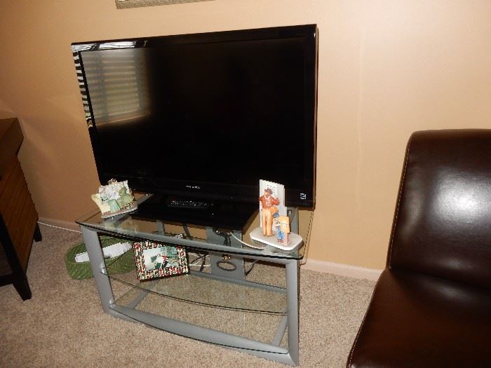 flat screen tv and stand tv by Dynex and is 42 inch screen.  The stand is 39x21x21