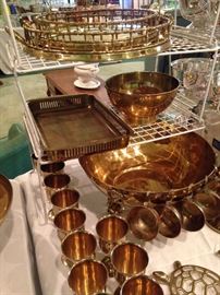 Brass trays, punch bowl, and cups