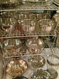 Some of the many silver plate bowls and trays