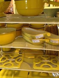 Yellow pots, pans, banana split dishes, trivets, etc