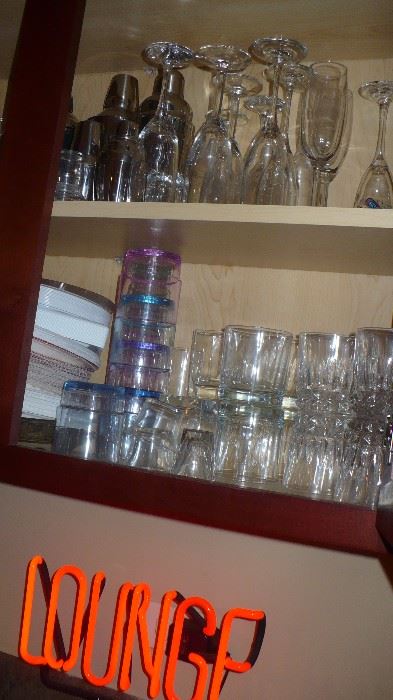 many bar glasses and other bar items