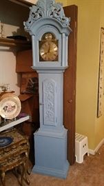 grandfather clock painted Swedish blue.  wants to run but doesn't sit well on the carpet