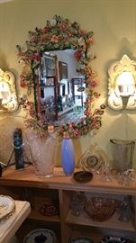 over the top enameled metal flower sculpture mirror.  yes it has dust, yes you must clean.  i did my best.  the lighted sconces are for sale too.