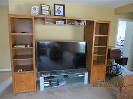 Oak twin book case with over head joiner for large TV.