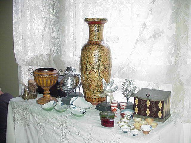 Many accessories, including Asian as well as contemporary boxes and shells sculptures on stands