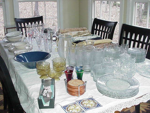 Table full of kitchen serving pieces and glassware