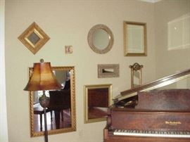 Wall of mirros and standing floor lamp