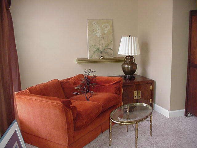 Loveseat; Chinese chest, two door, Brass and glass coffee table; artwork