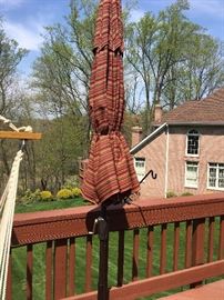 Like-new patio umbrella in cast iron stand