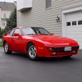 1985 Red Porsche 944: A 1985 Porsche 944 2-door coupe sports car. Seats four, has a cherry red coated finish, black leather interior, and 5-speed manual transmission. The car comes equipped with an Alpine AM/FM stereo, cassette deck, and a sunroof. VIN is WP0AA094XFN458244; mileage is 25,361.