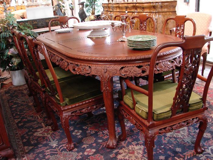 Dining set with grape design includes matching buffet. Note extra large lazy Susan in center of table and Flemish console in background.