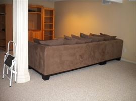 Quality L shaped sectional with matching ottoman. Also Leather round ottoman. Solid wood pine entertainment center with three seperate shelving units/book shelves.