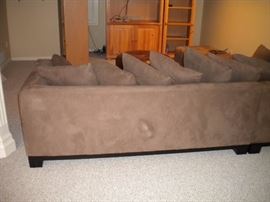 Quality L shaped sectional with matching ottoman. Also Leather round ottoman. Solid wood pine entertainment center with three seperate shelving units/book shelves.