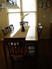 Sharp kitchen table and 6 chairs. Solid wood two tone with one leaf.