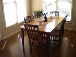 Sharp kitchen table and 6 chairs. Solid wood two tone with one leaf.