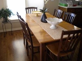 Sharp kitchen table and 6 chairs. Solid wood two tone with one leaf.