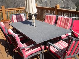 Patio set with 6 chairs, red cushions, seperate umbrella and stand, 4 chaise outdoor lounge chairs with red cushions.