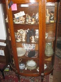 Curved glass china cabinet - many Hummel figurines