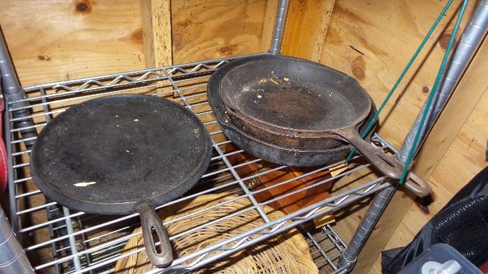 Large collection of cast iron pots and pans (Wagner’s, Lodge) and tools
•	Fire place screen,
•	Fire tending tools
•	3 firewood holders
