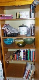 cook books, mixing bowls, bullet mixer, many crock pots, kitchen linens