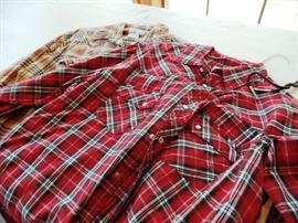 Lots of men's plaid shirts, jeans, pants and jackets